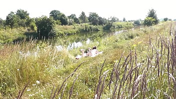 A casual passerby young guy saw a naked Milf sunbathing on river bank. Peeping. Spy camera. Naked in public. Nude beach. Wild beach