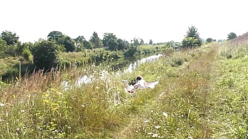 A casual passerby young guy saw a naked Milf sunbathing on river bank. Peeping. Spy camera. Naked in public. Nude beach. Wild beach