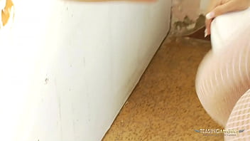 Busty brunette girl having fun with a dick in the glory hole