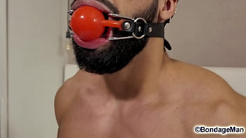 Leo Oliver muscular naked guy is tied up in the bed, ballgagged, bandana gag helpless struggling | PREVIEW