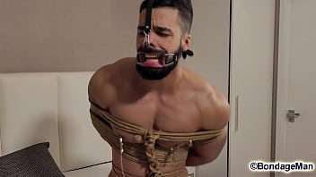 Leo Oliver muscular naked guy is tied up in the bed, ballgagged, bandana gag helpless struggling | PREVIEW