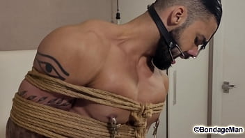 Leo Oliver muscular naked guy is tied up in the bed, ballgagged, bandana gag helpless struggling | PREVIEW
