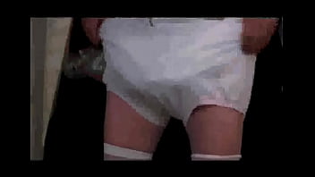 Diapered sissy in choker and chastity