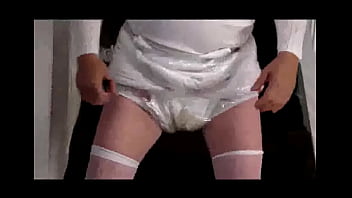 Diapered sissy in choker and chastity