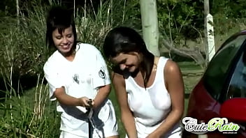 Cute rain gets wet washing car with lesbo
