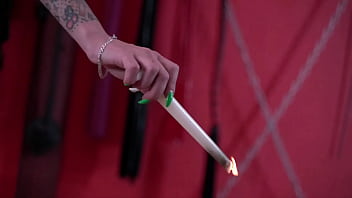 Hot wax from a candle for the body of a slave. Slender legs worship