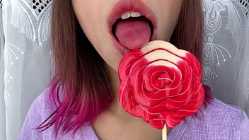 Naughty stepsister sucks a lollipop and show her long hot sexy tongue