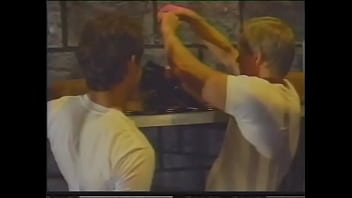 A long-haired brunette in a corset fucks at the same time with two athletic stallions and sucks their tight trunks