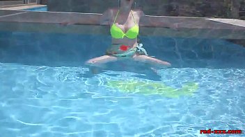 Mature redhead Red XXX masturbating in the pool