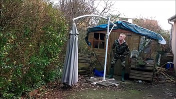 vintage - smoking guy in camo and rubber boots undressing