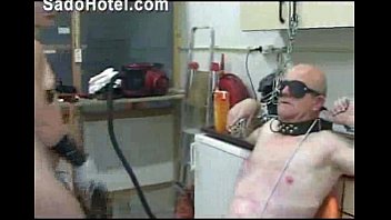 Mistress putting a gasmask on slaves face