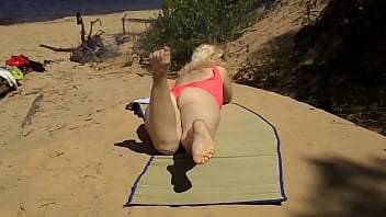 Blonde flashing pussy on the beach