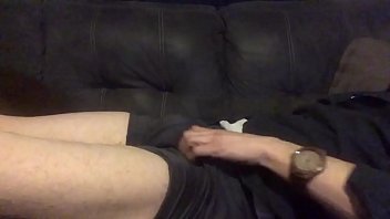 Hot guy with his pants down and dick out, tattoo guy strokes large cock with cock-ring, cumshot