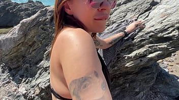 Hot brunette fucks a stranger on a public beach