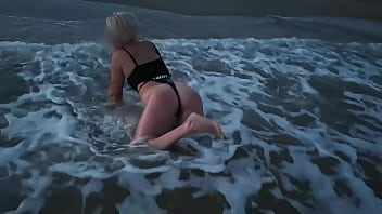 Blonde shows tits and sucks cock on a public beach