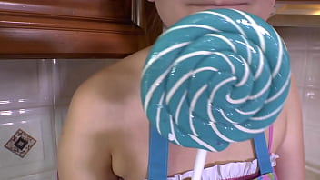 Brunette sucks on a lollipop in high heels