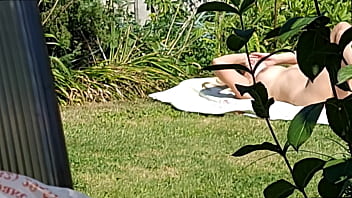I spy on my stepmother, she is sunbathing naked in the yard