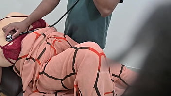 Indian doctor checking lady patient in clinic