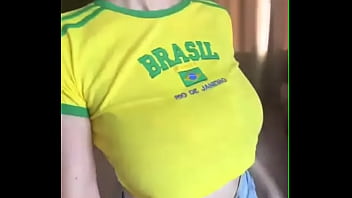 Playful stepmother in a Brazil T-shirt shows her young tits