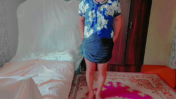 Playful sissy sitting cross-legged on fluffy pink carpet