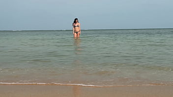 Slender beauty walks along the beach and swims in the sea. meet me
