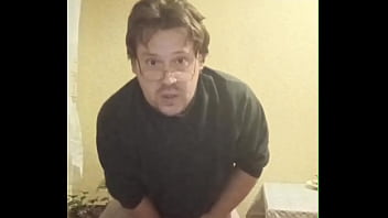 A tattooed gay man in glasses is riding a cucumber!