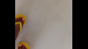 She is teasing with her bare feet wearing flip flops