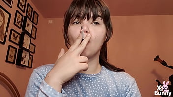 Big lips covered in lipgloss smoking with close up of the lips