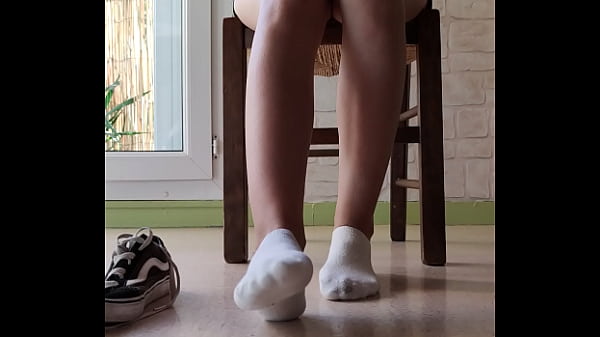 Candid girl feet in white socks