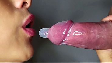 Close-up of a wet blowjob with a condom. Beautiful lips warm my cock