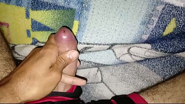Young man masturbates his big, tasty cock while wearing shorts
